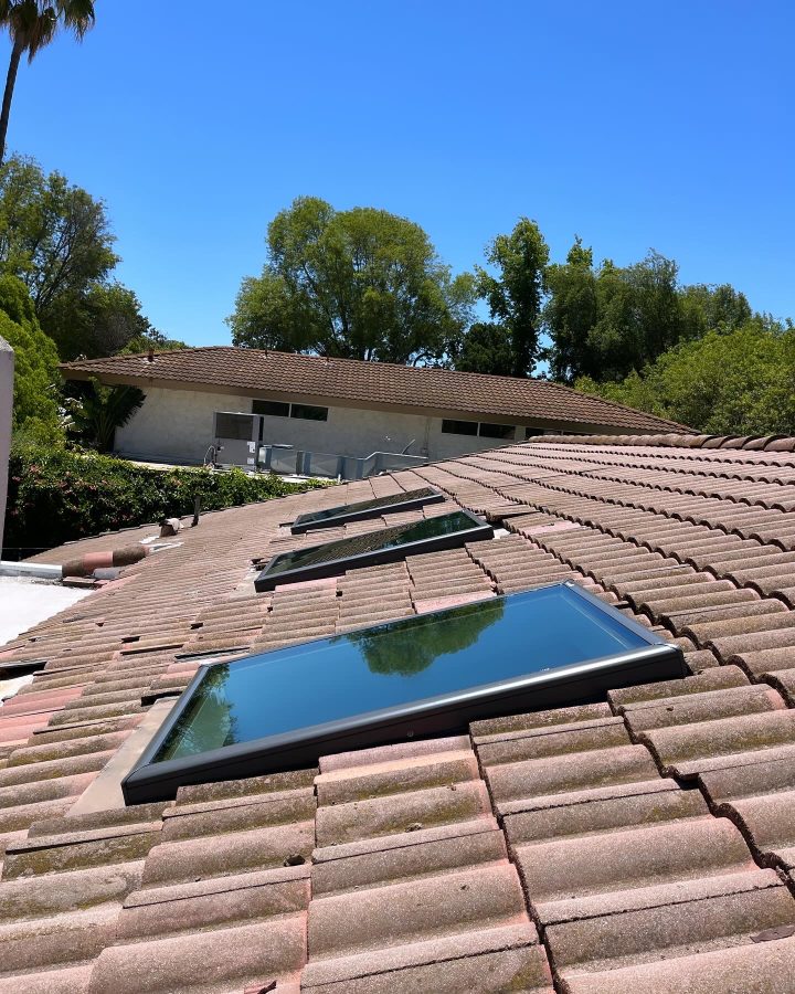 Three Velux FCM 3046 skylights on clay tile roof — Los Angeles